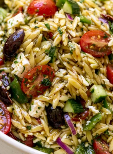 Colorful Greek Orzo Salad with fresh vegetables and feta cheese