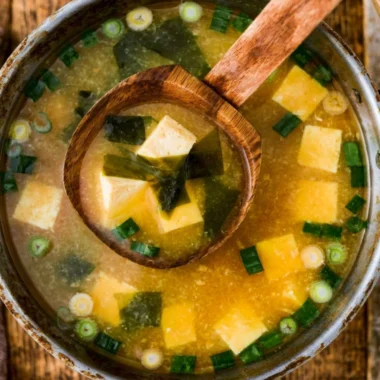 Bowl of homemade miso soup with tofu, green onions, and seaweed