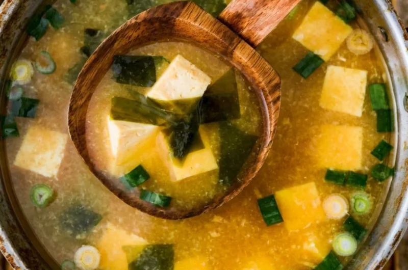 Bowl of homemade miso soup with tofu, green onions, and seaweed
