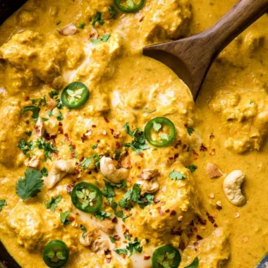Delicious Indian curry served in a traditional bowl with spices and herbs.