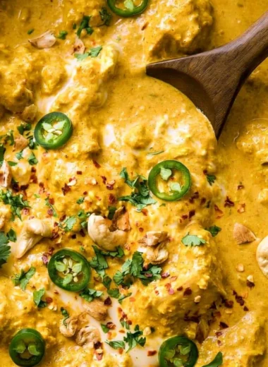 Delicious Indian curry served in a traditional bowl with spices and herbs.