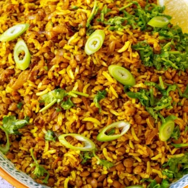 Bowl of Mediterranean lentils and rice garnished with fresh herbs and spices