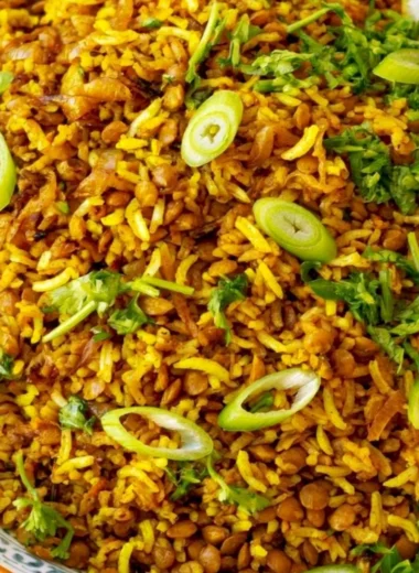 Bowl of Mediterranean lentils and rice garnished with fresh herbs and spices