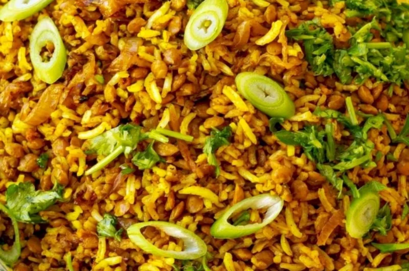 Bowl of Mediterranean lentils and rice garnished with fresh herbs and spices