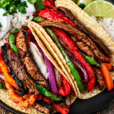 Plate of Portobello vegan fajitas with colorful peppers and onions